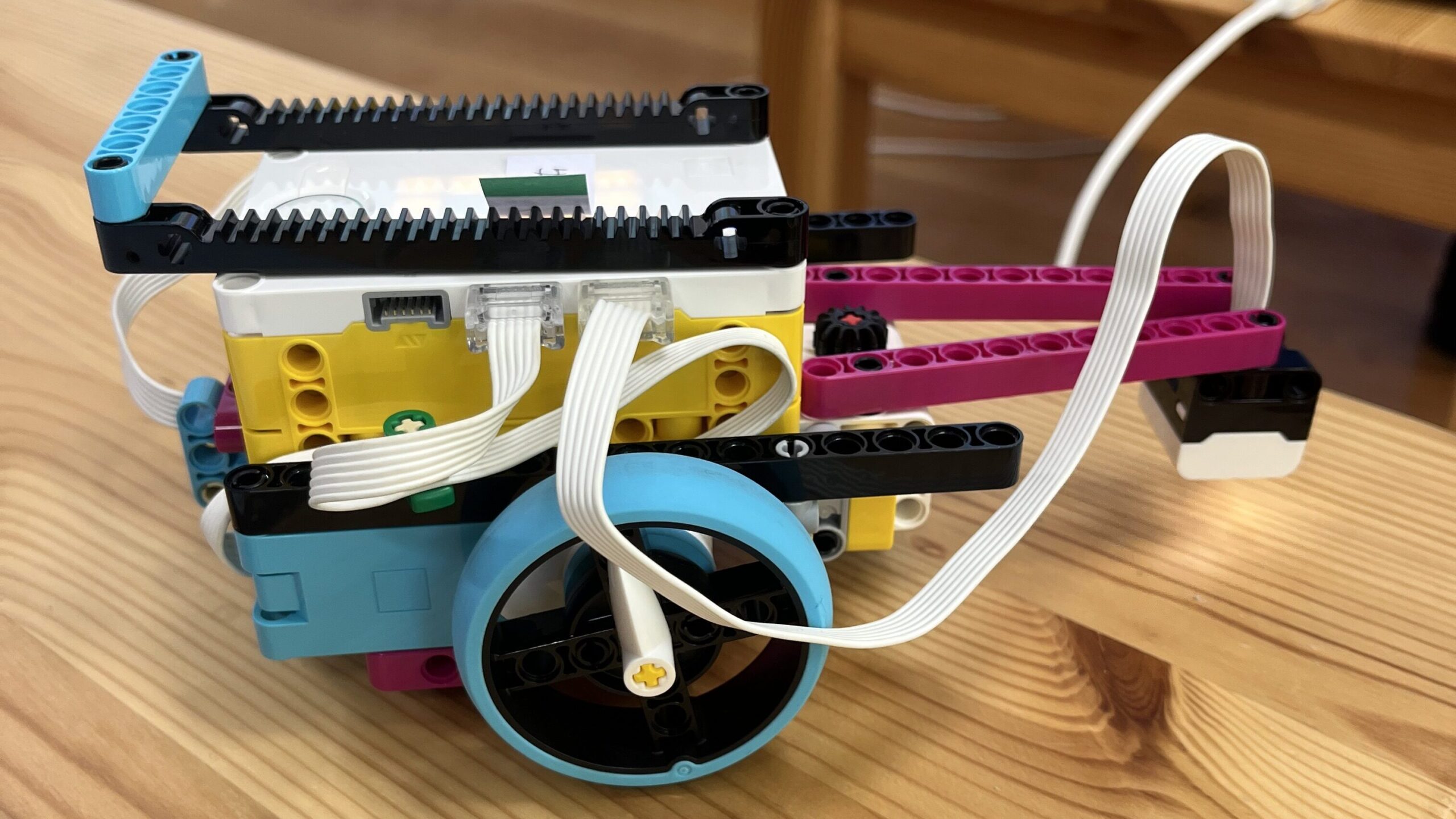 木のテーブルの上に置かれた、レゴ エデュケーション SPIKE プライムで作られた2輪走行型のロボット